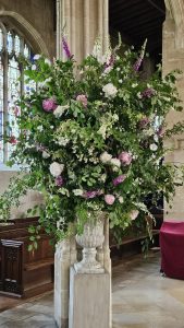 Flowers in front of pillar - North Side